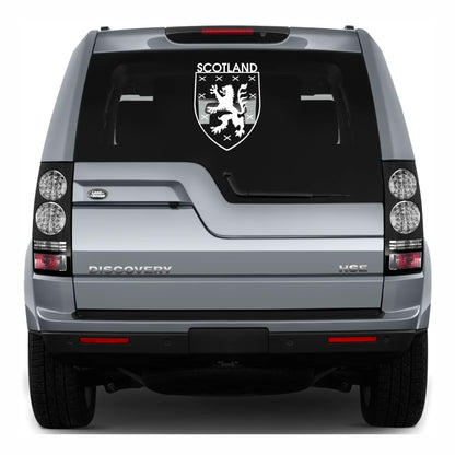Back view of a Land Rover Discovery with a Scotland emblem decal on the glass.