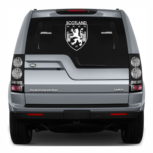 Back view of a Land Rover Discovery with a Scotland emblem decal on the glass.